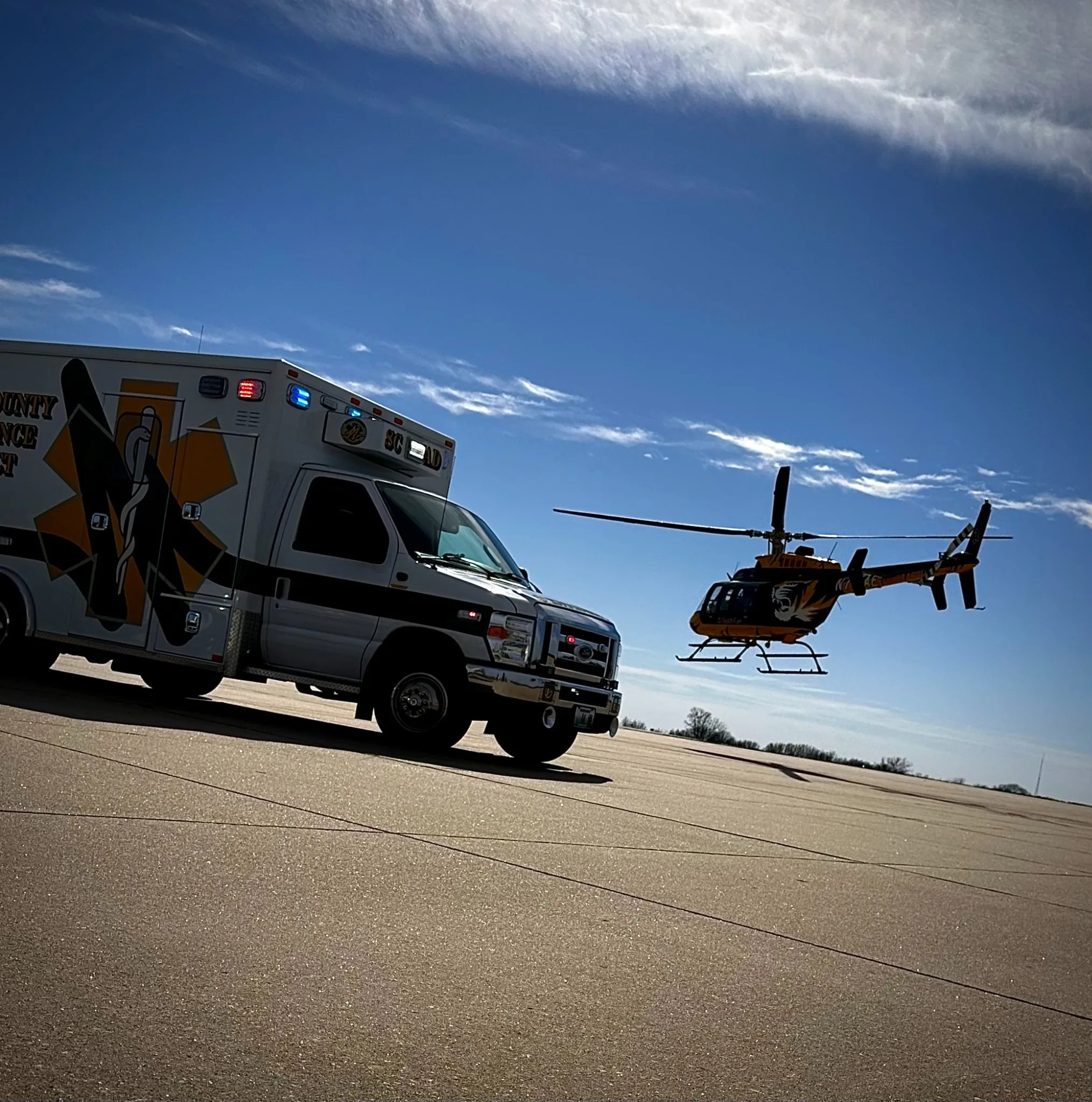 Ambulance with helicopter in background